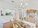 Open concept dining room with kitchen and glass top dining table at 1405 W Schwartz Blvd, The Villages, FL 32159