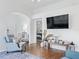 Living room with comfy seating, wood floors and view into bedroom at 1405 W Schwartz Blvd, The Villages, FL 32159
