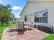 Brick patio with table and chairs, adjacent to home at 1405 W Schwartz Blvd, The Villages, FL 32159