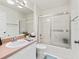 Clean bathroom with a pink vanity, shower/tub combo, and a large mirror at 1405 W Schwartz Blvd, The Villages, FL 32159