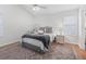 Bright bedroom with a queen-size bed, wood floors and ceiling fan at 1405 W Schwartz Blvd, The Villages, FL 32159
