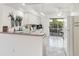 Kitchen features white cabinets, tiled floor, and a breakfast bar at 1405 W Schwartz Blvd, The Villages, FL 32159