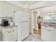 Kitchen with white appliances and view into dining and living areas at 1405 W Schwartz Blvd, The Villages, FL 32159