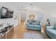 Open living room and dining area with light teal sofas and wood floors at 1405 W Schwartz Blvd, The Villages, FL 32159
