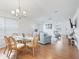Bright dining area with glass-top table, light wood floors, and wicker chairs at 1405 W Schwartz Blvd, The Villages, FL 32159