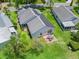 Aerial view showcasing a home's backyard, patio, and solar panels at 1405 W Schwartz Blvd, The Villages, FL 32159