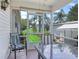 Spacious screened porch, overlooks grassy backyard with palm trees at 1405 W Schwartz Blvd, The Villages, FL 32159