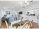 Open dining area with a glass table, light flooring and view into the living room at 1405 W Schwartz Blvd, The Villages, FL 32159