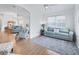 Open concept living room with teal sofas, wood floors and ceiling fan at 1405 W Schwartz Blvd, The Villages, FL 32159