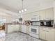 White kitchen with appliances, corner sink, and ample counter space at 1405 W Schwartz Blvd, The Villages, FL 32159
