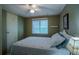 Guest bedroom with ceiling fan and window with blinds at 1306 Westland Dr, Tavares, FL 32778