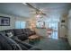Open concept living room with kitchen view and sectional sofa at 1306 Westland Dr, Tavares, FL 32778