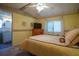 Comfortable bedroom with ceiling fan, dresser and ensuite bathroom at 1306 Westland Dr, Tavares, FL 32778