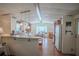 Open kitchen features a breakfast bar and views into the living room at 1306 Westland Dr, Tavares, FL 32778