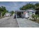 Mobile home exterior with covered porch and American flag at 1306 Westland Dr, Tavares, FL 32778