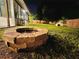 Brick fire pit in backyard at night at 14598 Sw 34Th Terrace Rd, Ocala, FL 34473