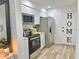 Modern kitchen with white cabinets, stainless steel appliances, and wood countertops at 14598 Sw 34Th Terrace Rd, Ocala, FL 34473