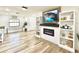 Living room with fireplace, built-in shelving, and wood-look flooring at 14598 Sw 34Th Terrace Rd, Ocala, FL 34473