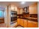 Kitchen with wood cabinets, granite counters, and stainless steel appliances at 601 W Old Hwy 441 # 11B, Mount Dora, FL 32757
