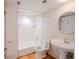 Clean bathroom with a bathtub, toilet, and pedestal sink at 601 W Old Hwy 441 # 11B, Mount Dora, FL 32757