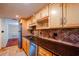 Kitchen boasts wood cabinets, granite countertops, and stainless steel appliances at 601 W Old Hwy 441 # 11B, Mount Dora, FL 32757