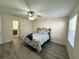 Bedroom with a full bed, ceiling fan and en-suite bathroom at 12046 Ne 51St Cir, Oxford, FL 34484