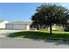 Two-car garage and well-maintained lawn at 12046 Ne 51St Cir, Oxford, FL 34484