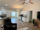 Open concept kitchen features white cabinets, granite counters, and wine fridge at 12046 Ne 51St Cir, Oxford, FL 34484