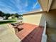 Side patio with brickwork seating area and view of neighborhood at 12046 Ne 51St Cir, Oxford, FL 34484