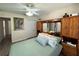 Bedroom with a queen bed and wood closet doors at 12046 Ne 51St Cir, Oxford, FL 34484