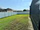 Large grassy backyard area with a privacy fence at 12046 Ne 51St Cir, Oxford, FL 34484