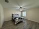 Spacious bedroom with hardwood floors and ceiling fan at 12046 Ne 51St Cir, Oxford, FL 34484
