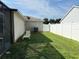 Side yard with grassy area and privacy fence at 12046 Ne 51St Cir, Oxford, FL 34484