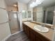 Double vanity bathroom with shower and plenty of counter space at 12046 Ne 51St Cir, Oxford, FL 34484
