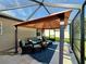 Screened patio with gazebo and comfortable seating at 12046 Ne 51St Cir, Oxford, FL 34484