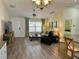 Bright living room with hardwood floors and access to patio at 12046 Ne 51St Cir, Oxford, FL 34484