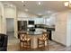 Modern kitchen with L-shaped island, granite countertops, and stainless steel appliances at 12046 Ne 51St Cir, Oxford, FL 34484