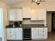 Kitchen wet bar with wine cooler and granite countertop at 12046 Ne 51St Cir, Oxford, FL 34484