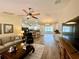 Open-concept living room with kitchen and hardwood floors at 12046 Ne 51St Cir, Oxford, FL 34484
