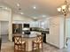 Modern kitchen with island, granite countertops, and stainless steel appliances at 12046 Ne 51St Cir, Oxford, FL 34484