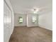 Spacious bedroom with carpet, ceiling fan, and ample closet space at 5072 Neptune Cir, Oxford, FL 34484