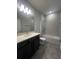 Clean bathroom with single vanity, tub and tile flooring at 2003 Sunshine Peak Dr, Minneola, FL 34715