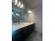 Modern bathroom with double vanity and a large mirror at 2003 Sunshine Peak Dr, Minneola, FL 34715
