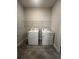 Laundry room with washer, dryer, and overhead shelving at 2003 Sunshine Peak Dr, Minneola, FL 34715