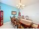 Bright dining room with a large table, chandelier, and decorative accents at 172 Seville Dr, Davenport, FL 33837