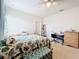 Spacious bedroom with a king-size bed, desk area, and ceiling fan at 172 Seville Dr, Davenport, FL 33837