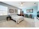 Bright bedroom with a queen-size bed, two chairs, and a ceiling fan at 172 Seville Dr, Davenport, FL 33837