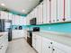 White kitchen cabinets and countertops, stainless steel appliances at 172 Seville Dr, Davenport, FL 33837