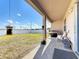 Covered patio, grassy yard, and grilling area at 172 Seville Dr, Davenport, FL 33837