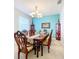 Elegant dining room featuring a large wood table, chandelier, and built-in hutch at 172 Seville Dr, Davenport, FL 33837